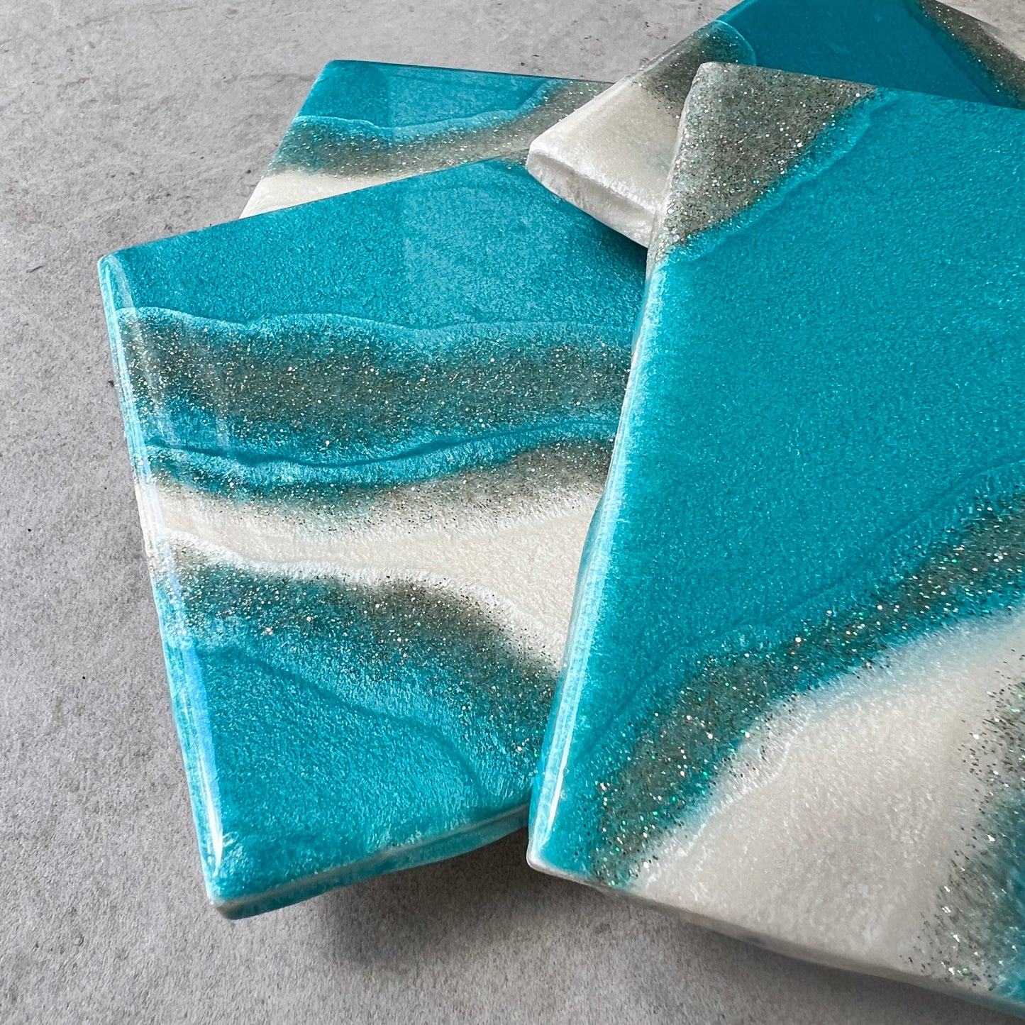 4 pc coasters in blue,silver and white