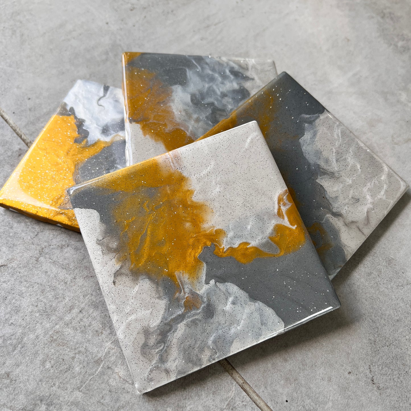 4 pc coasters in gold, white, grey