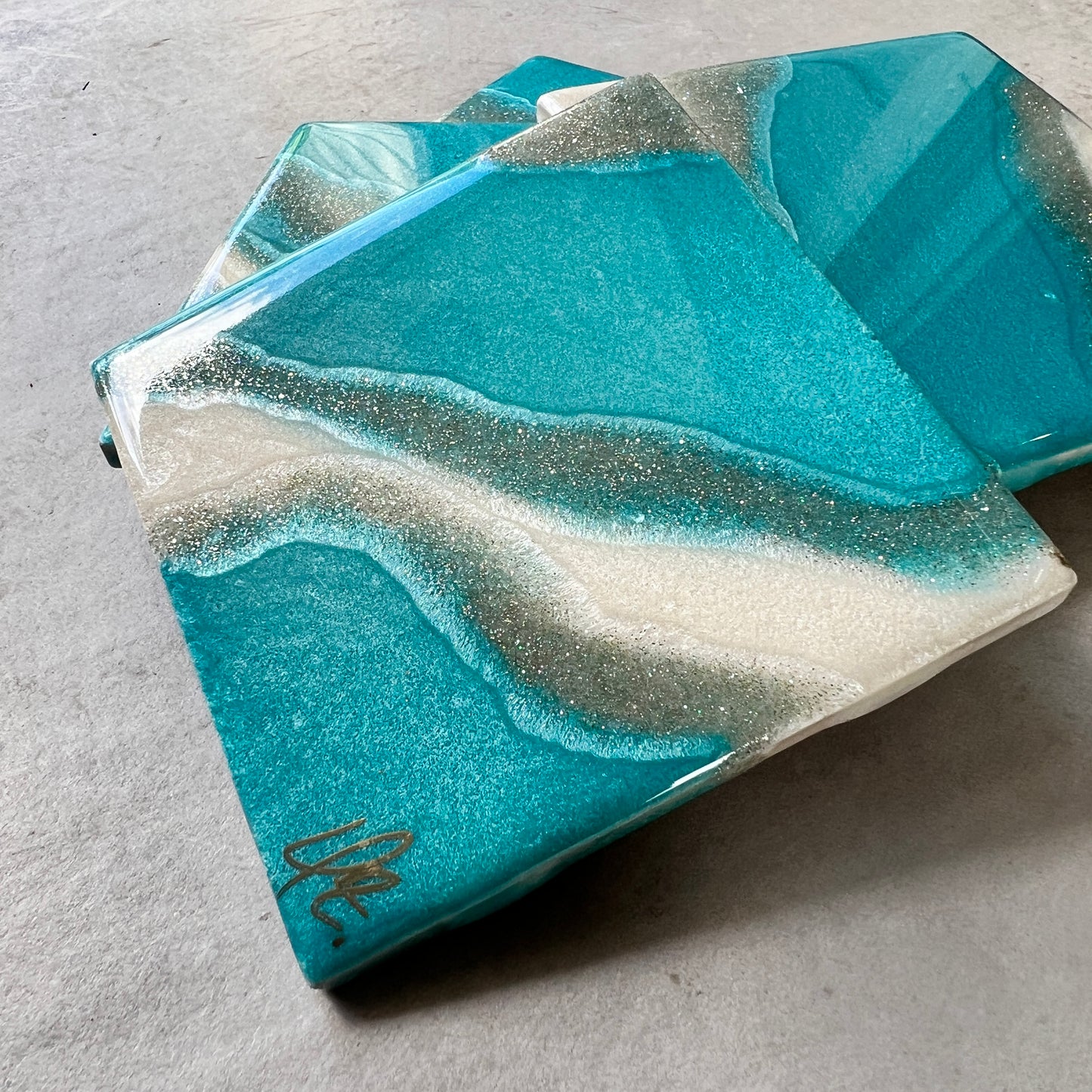 4 pc coasters in blue,silver and white