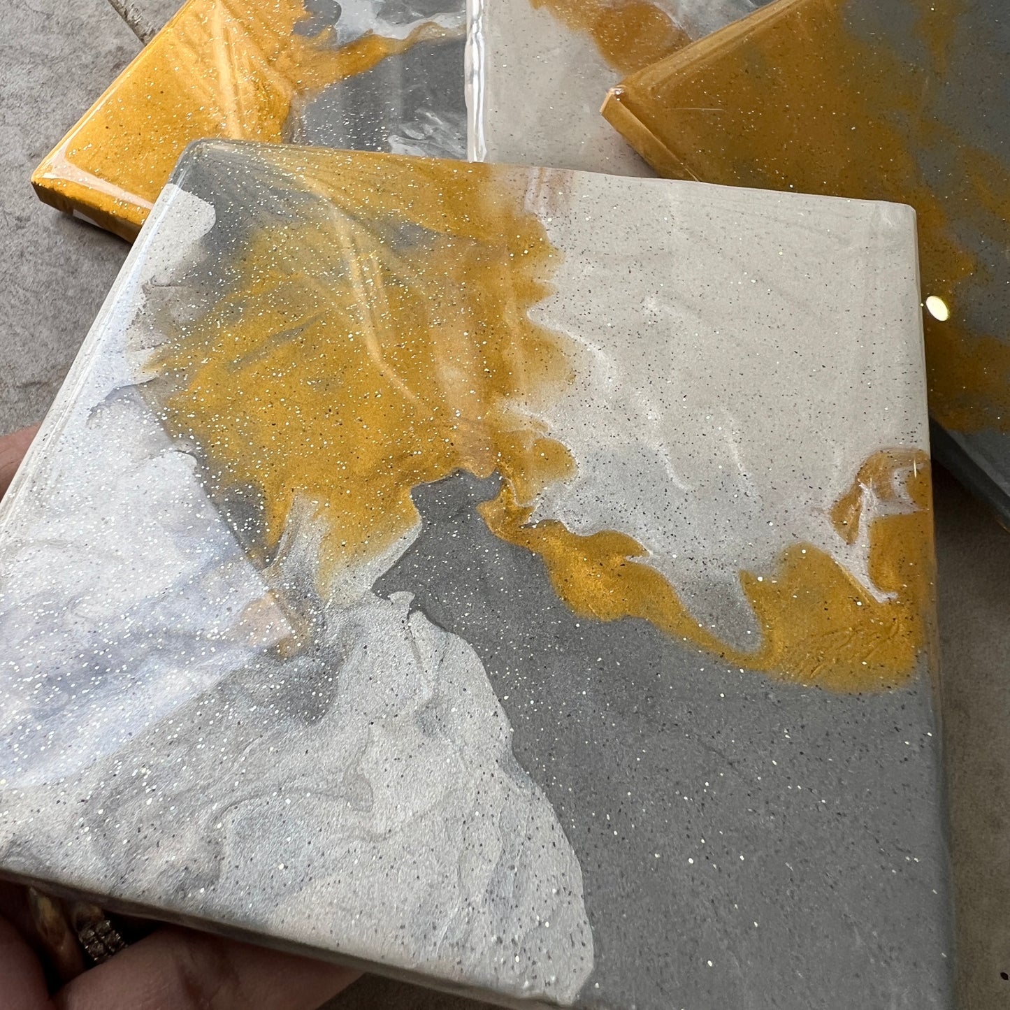 4 pc coasters in gold, white, grey