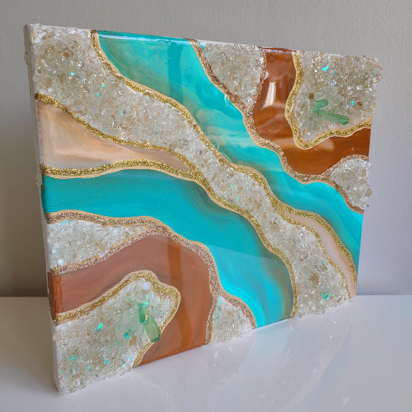 Turquoise and caramel geode artwork with glass and crystals