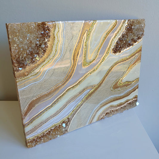 Cream and bronze artwork with glass on wood