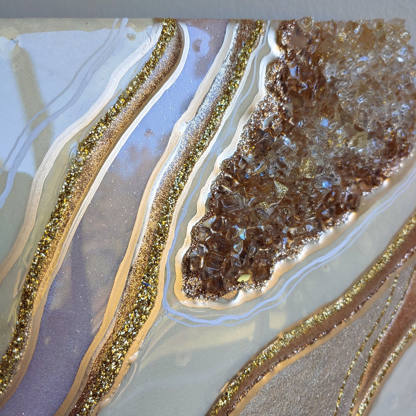 Cream and bronze artwork with glass on wood