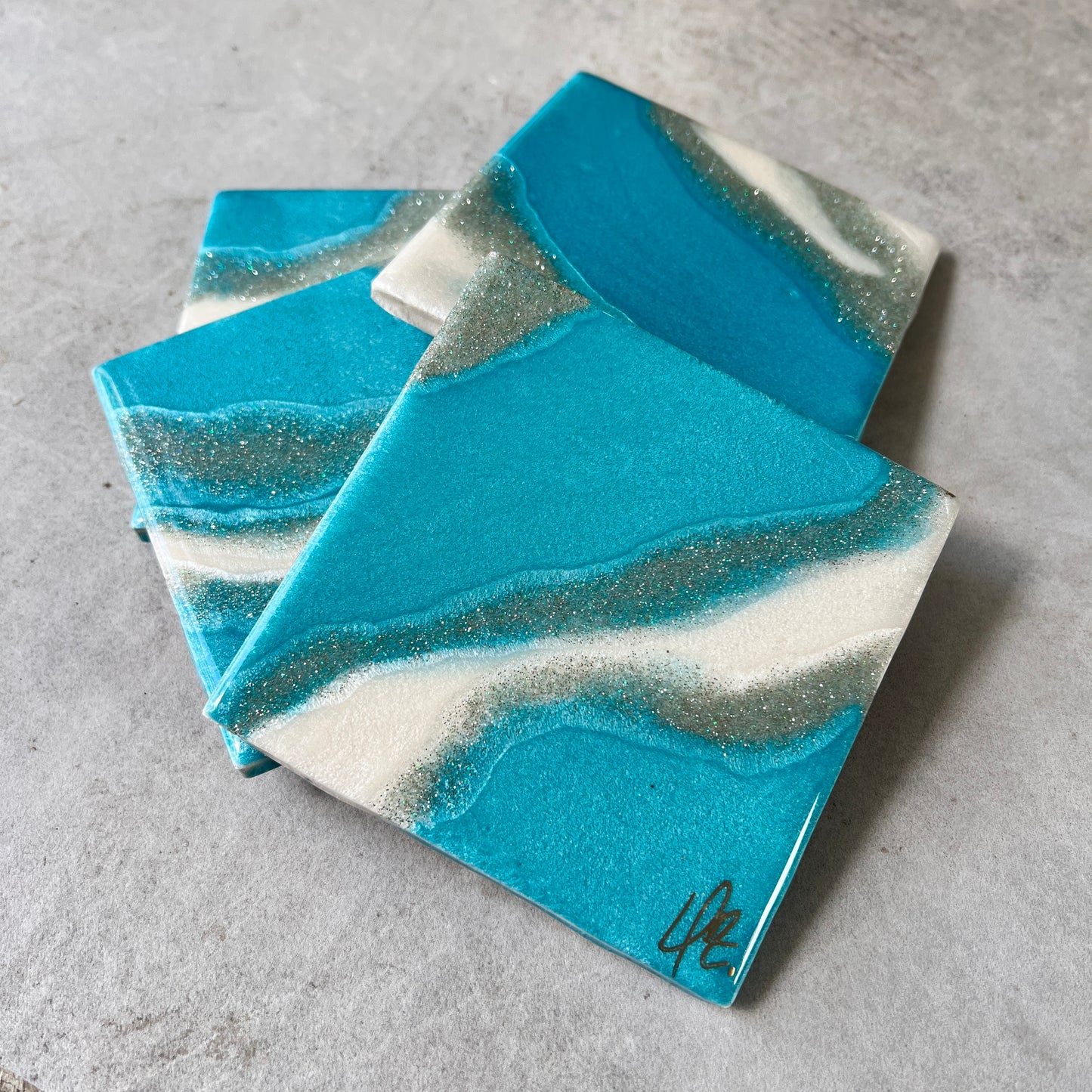 4 pc coasters in blue,silver and white